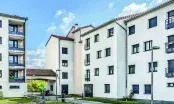 Façade blanche de deux immeubles de logements collectifs après isolation thermique par l'extérieur, par temps clair