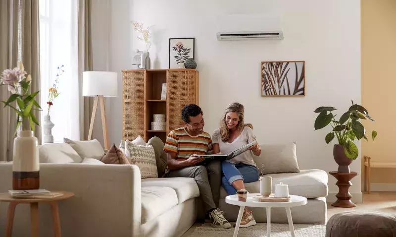 Climatiseur Qlima SC 7026 blanc monté sur un mur dans une pièce à la décoration moderne